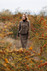 a lady in a brown wool jacket and skirt two-piece set